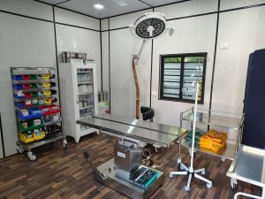 Interior of a OT with medical equipment and a bed, highlighting the modular operation theater by Kalyan Jivashray Foundation.